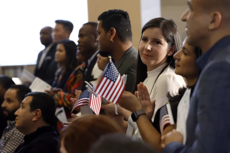 2022 年 10 月 19 日在费城举行的入籍仪式上，新入籍的美国公民挥舞着小旗帜。一项新研究着眼于移民与社会政策支持之间的关系，发现数十名研究人员发现了两者之间的不同关系。（图片来源（安娜摇钱树/盖蒂）